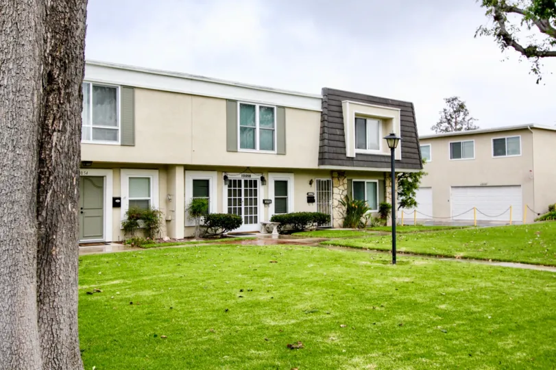 A apartment building with a long walkway in Chateau Blanc community.