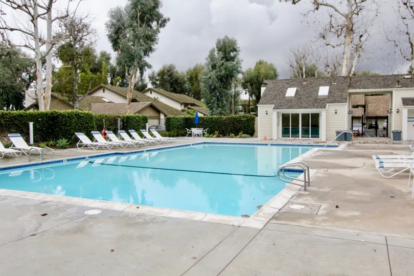 A refreshing pool with lounge chairs in the Emerald Glen community.