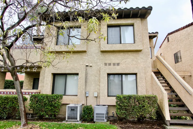 Tan color residential area with a porch and staircase located in the Fountain Crest community.