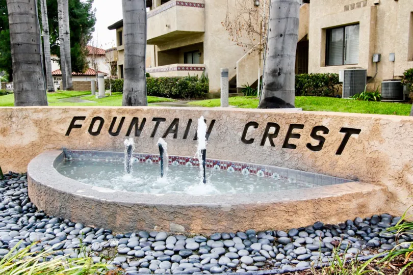 Stone entrance sign labeled Fountain Crest community.