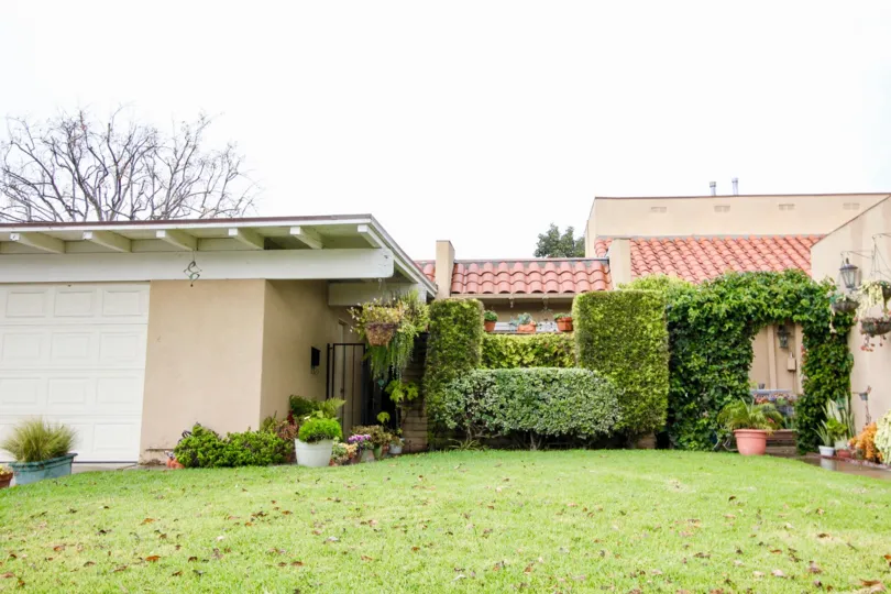 Green front yard on a bright day with a garage located in the community of Green Valley Townhomes