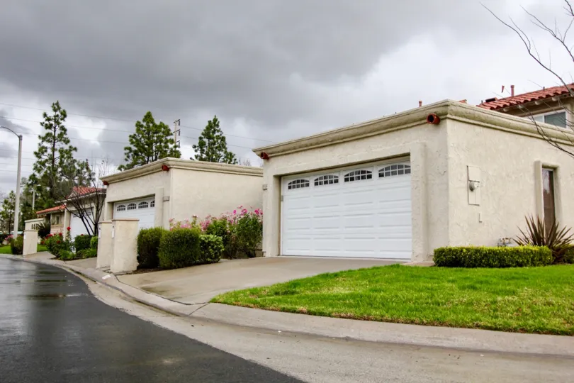 Residential area with two car garages close to the street located in the community of Green Valley Warner Village.