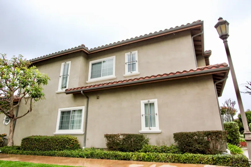 The side view of housing in the Liberty Founder of Village with street lighting and established landscaping.