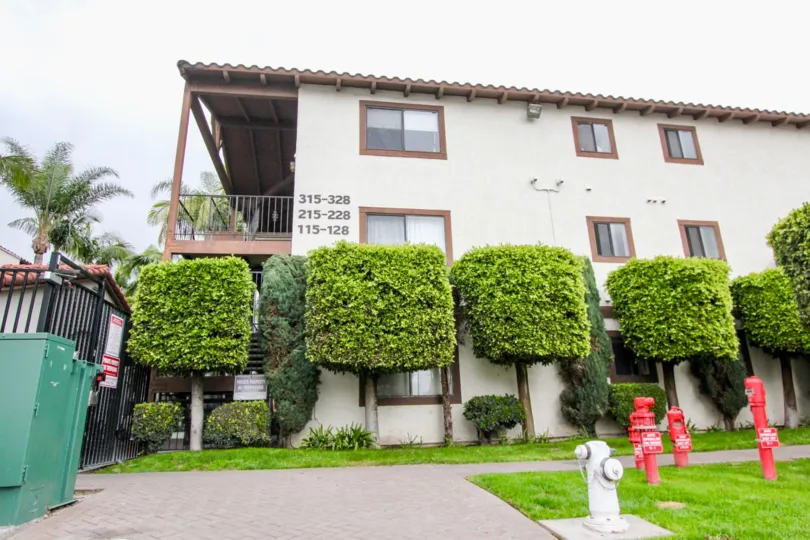Near gate entrance of villa in Los Caballeros has cutting plants decoratively with lawn and pumps