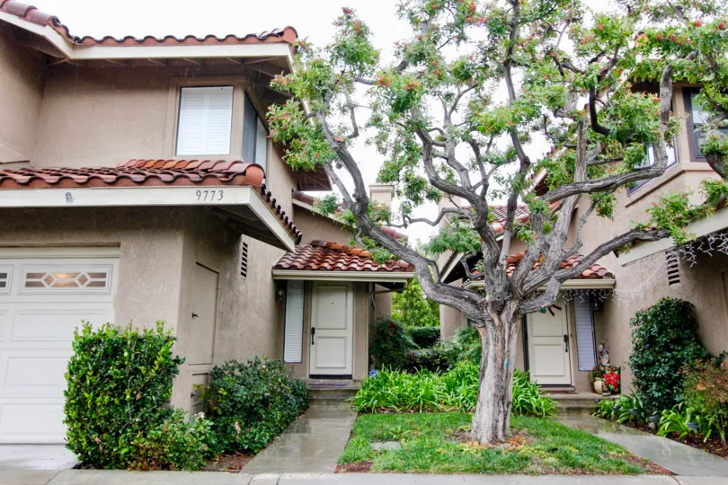 Center to two villa's in Mariposa has tree with flowers, plants and bushes