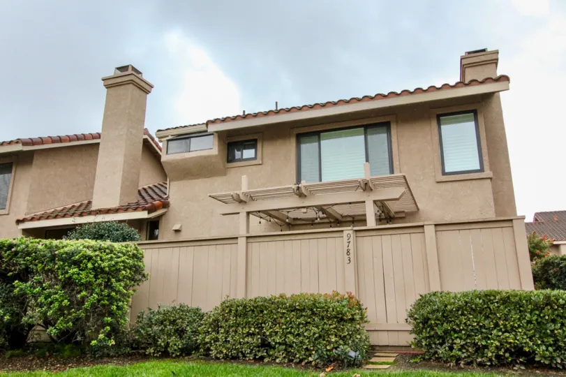 A tall cream fence providing privacy to the residential resident in Mariposa community.