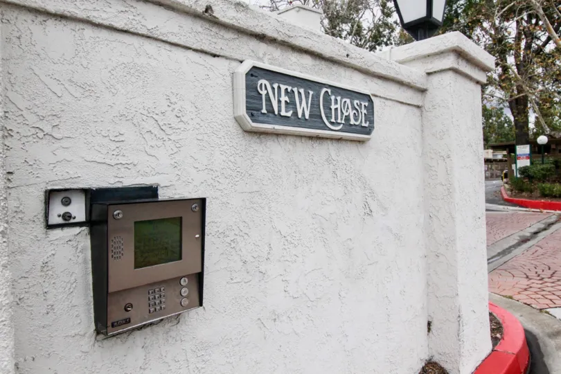 The board New chase is fixed in the wall where telephone booth is also fixed in the same wall
