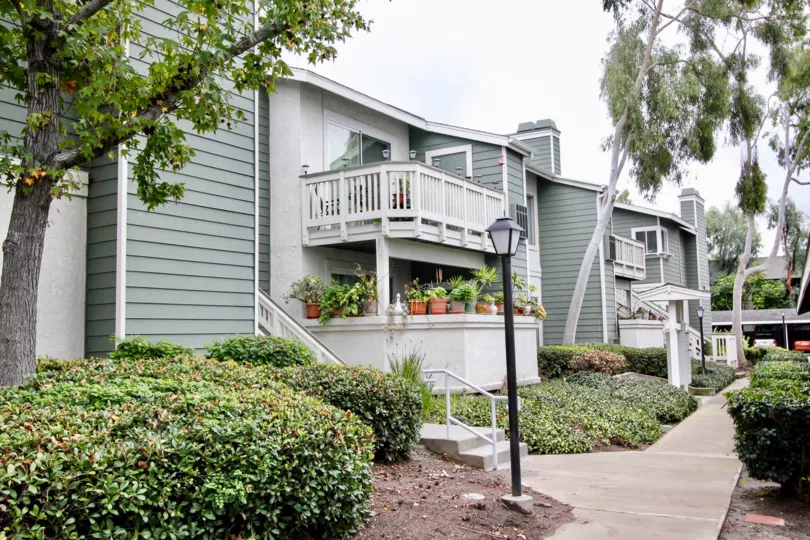 Gray housing structures with lots of plants around them at New Chase in Fountain Valley CA