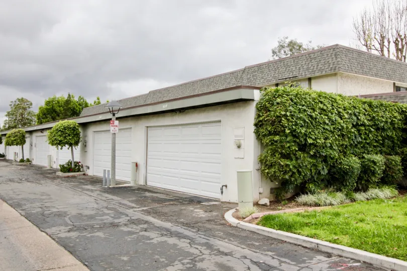 Cloudy day where you can see multiple garage doors closed that are all white in Tiburon North community.