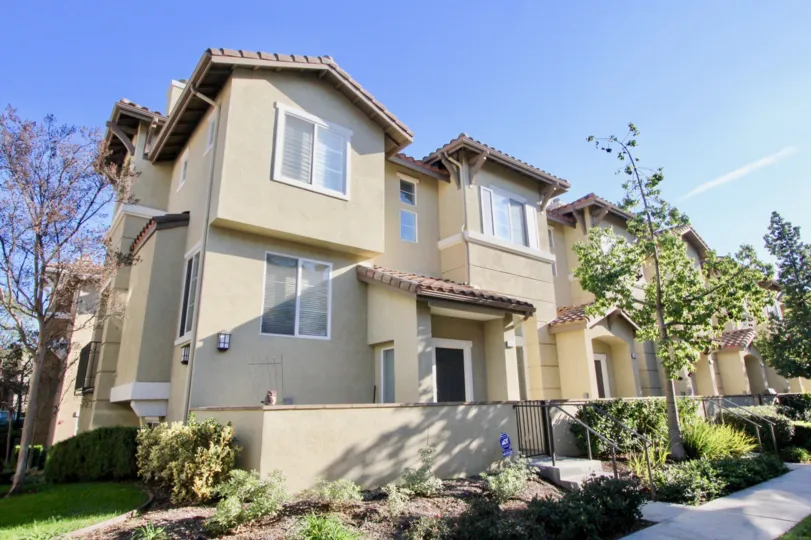 Very nice large light color townhomes with plants in Amerige heights community in fullerton, california.