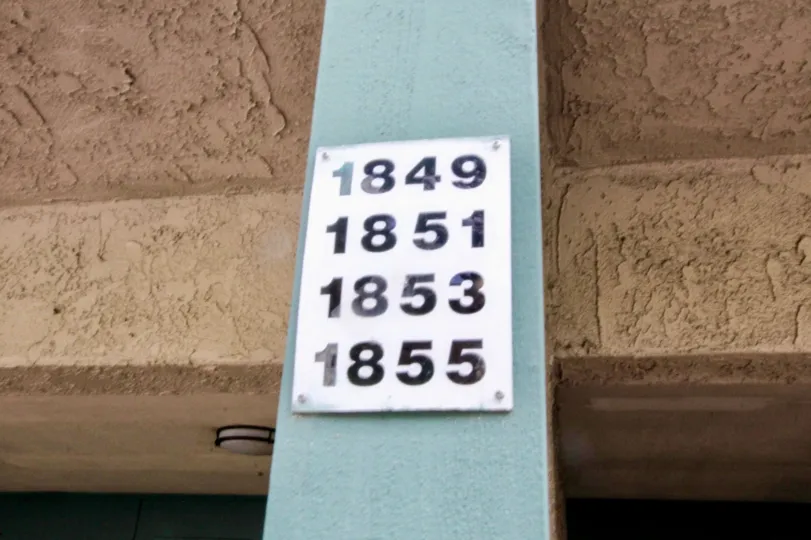 Brea Country Fullerton California with brown shrinked roofing model ceiling and four house numbers at front pillar