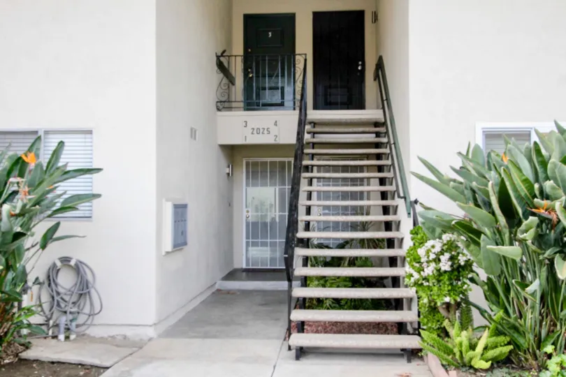 A staircase in the Casa Del Amo community with plants on either side.