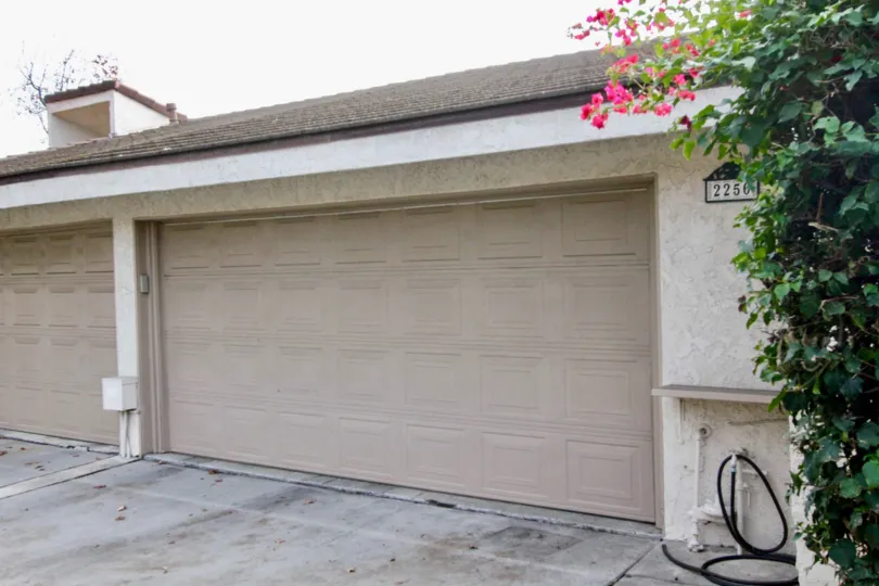 Car shed of villa is closed in Casa Del Vista with tap and flowers in plants