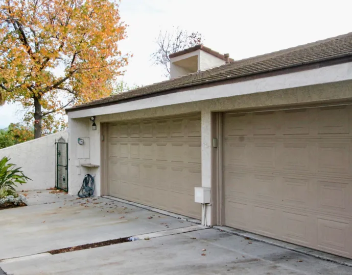 Garages in the Casa Del Vista community with a gate on a cloudy day.