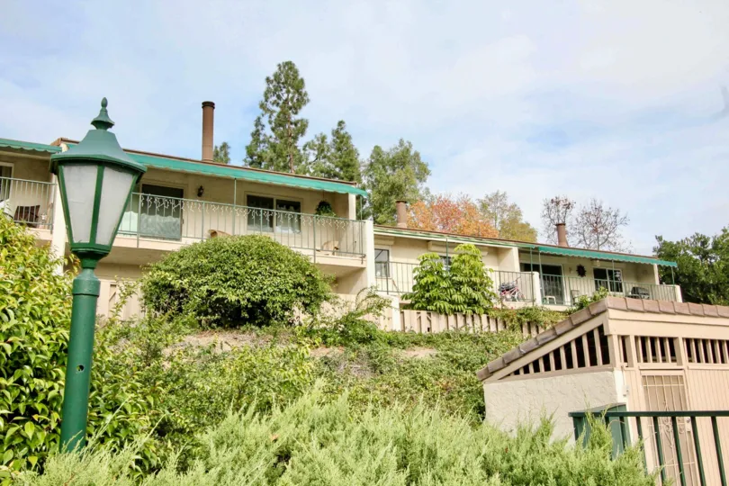 A building on top of a hill with a fence in Casa Del Vista on a sunny day.