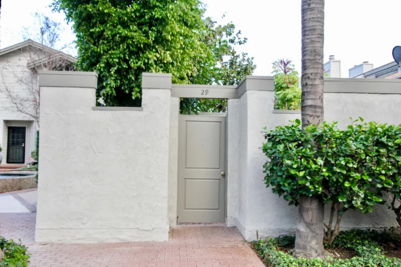 The sunny day in the Chapman Villas with backyard and garden.