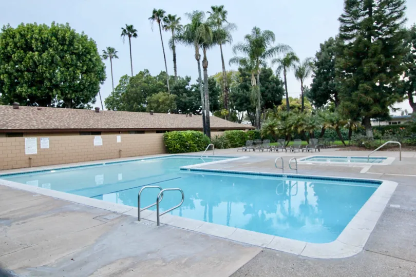A large pool and a small pool with chairs in coco palms community in fullerton, california.