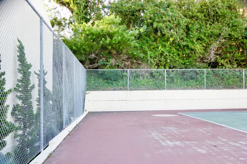 A play ground in the Country Villas with net compound, beautiful green plants, green shrubs and trees.
