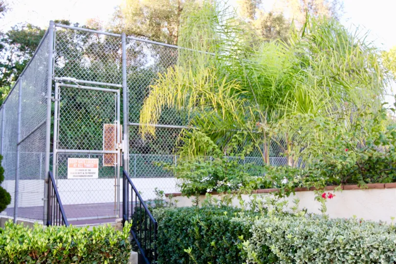 Tennis courts with plenty of trees and plants in the community of Country Villas, Fullerton CA.