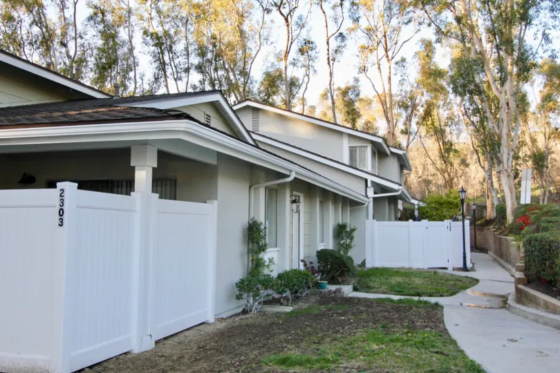 A home in Coyote Hills Bluffs with a fence and sidewalk.