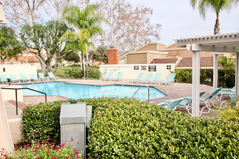 A pool area at Fairway Village in Fullerton, California with chairs to relax