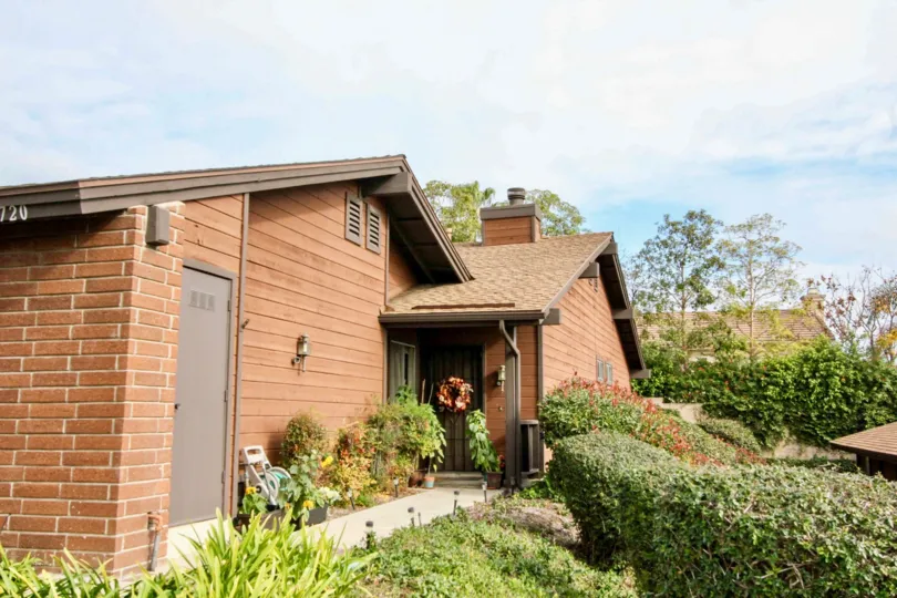 A large brown house with plants and bushes around it in fullerton pines community in fullerton, california.