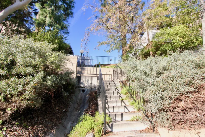 Staircase in the Gilbert Vista community surrounded by plants on a sunny day.