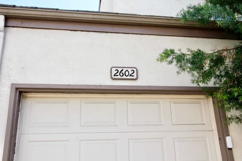 A street number of a home in Greenview Terrace with a garage below it.