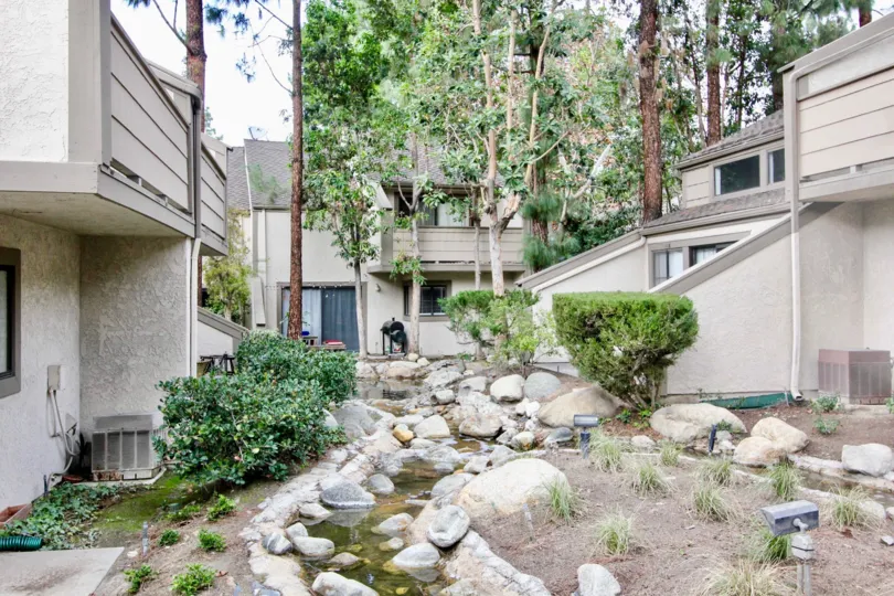Serene trickling stream in between buildings in Hidden Lakes.