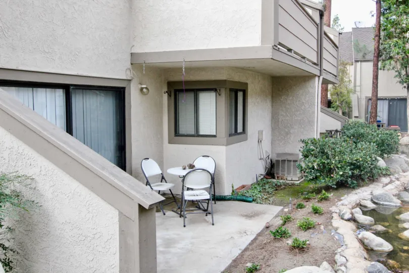 A patio section with a table in residential building in Hidden Lakes community.