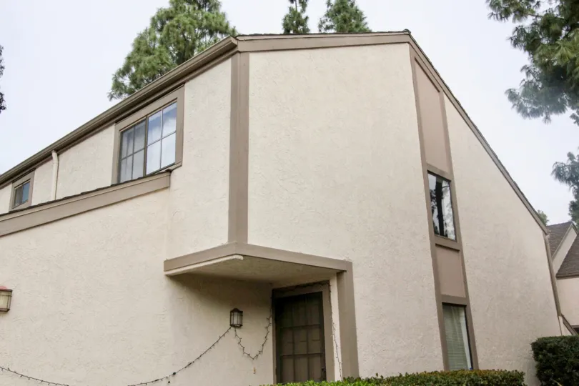 Unique shaped residential area with a black door with trees surround area located in the Hidden Lakes community.
