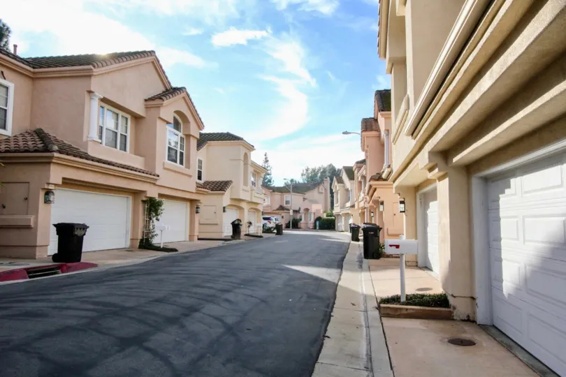 Street view of the private garages and mailboxes abound in Maison de Fleur, Fullerton, CA.
