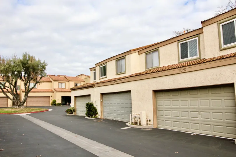 A apartment building in the Mark III Townhomes with garages on a cloudy day.