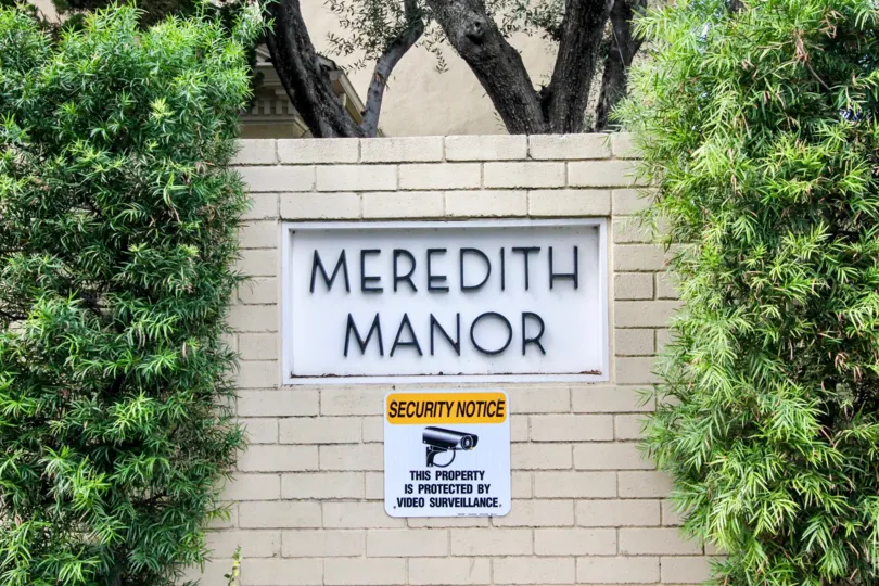In The wall of Meredith Manor has noticed a security warning that video camera should be there for protection