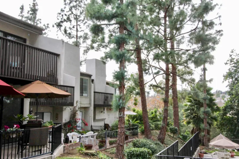 White two story townhomes with black gates and chairs at park vista community in fullerton, california.