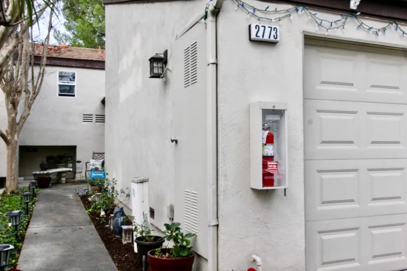 A sidewalk in the Park Vista community with a fire extinguisher and lamps.