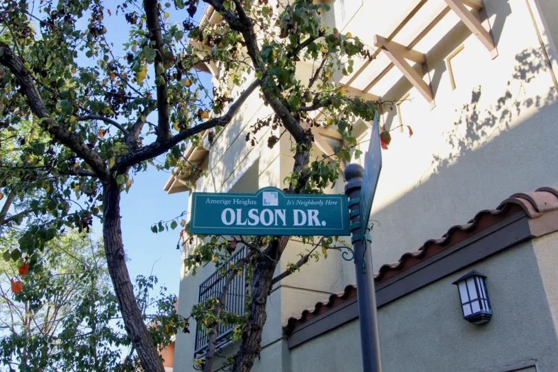A street sign in front of a tall building in the Plaza Walk community.