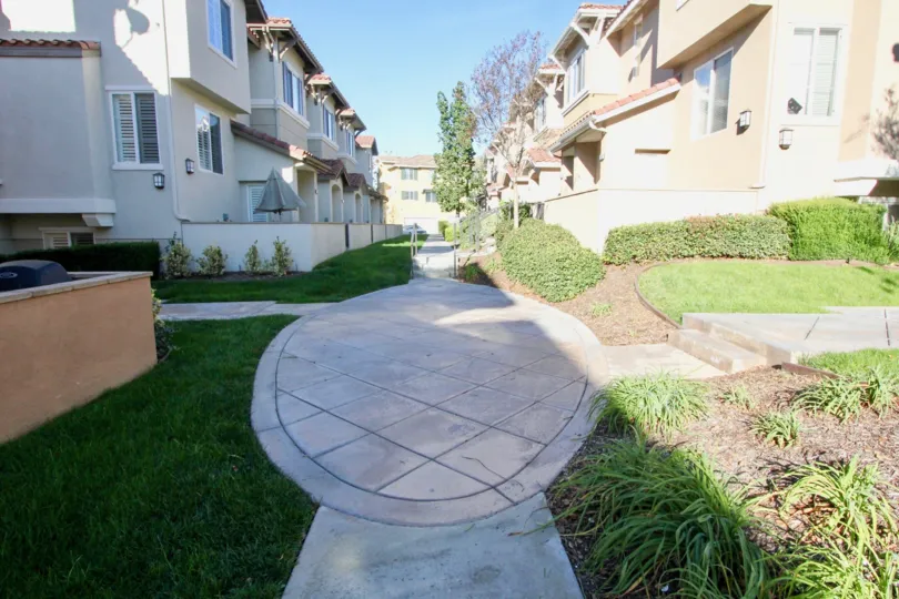 Plaza Walk courtyard with a walking path between apartment buildings.