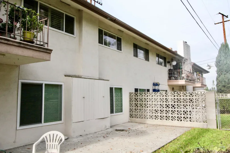 Two story residential building with brick privacy barrier in Shadow Lane community.