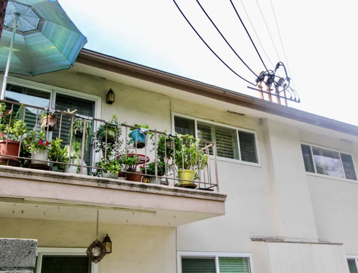 The sunny day in the Shadow Lane with Balcony villas and transformer lines.