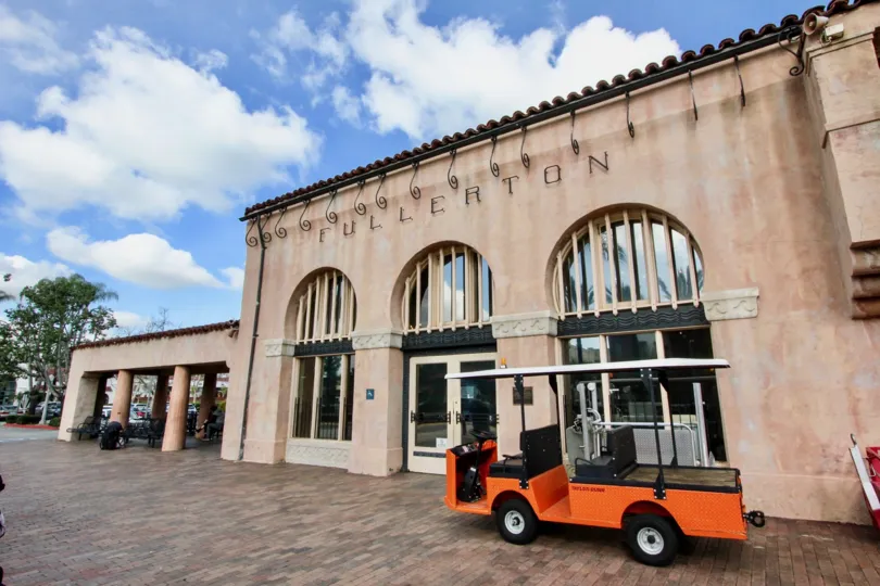 Soco Walk Fullerton California curved steel designed touches the front wall and a vehicle parked in front