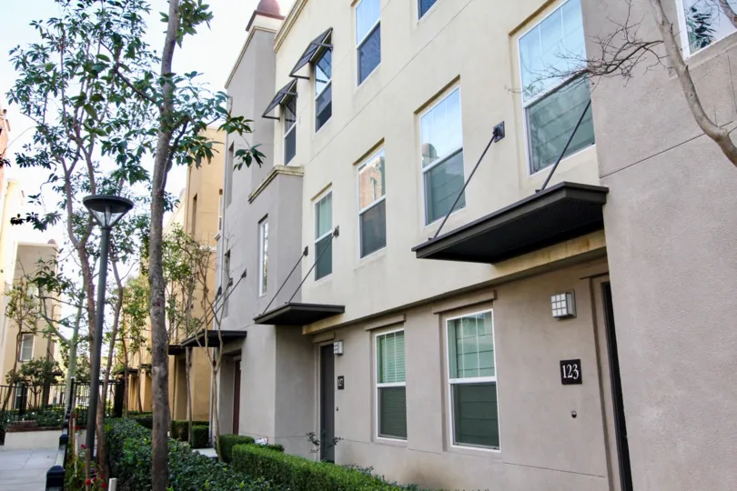A multi level building with rain barriers over doors in Soco Walk community.