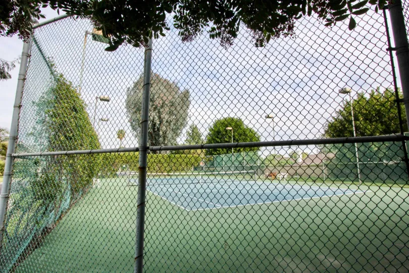 Fenced in tennis courts and light post Stone Pine Estates Fullerton CA