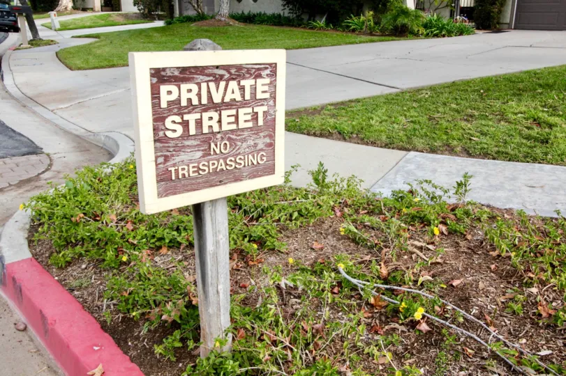 A no trespassing sign in the Stone Place community with sidewalks and driveways.