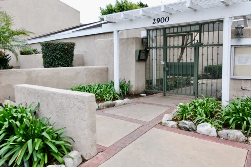 Bushes are grown and protected by small rocks at front of the gate in The Arbor