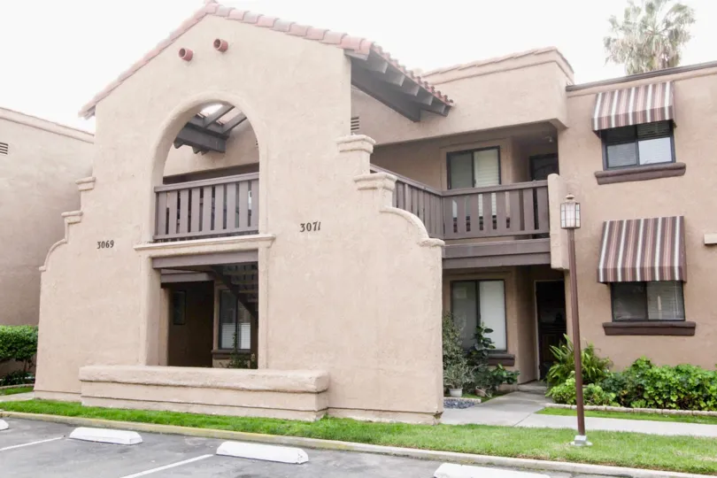 Two level building with large porch in Via Velencia community.