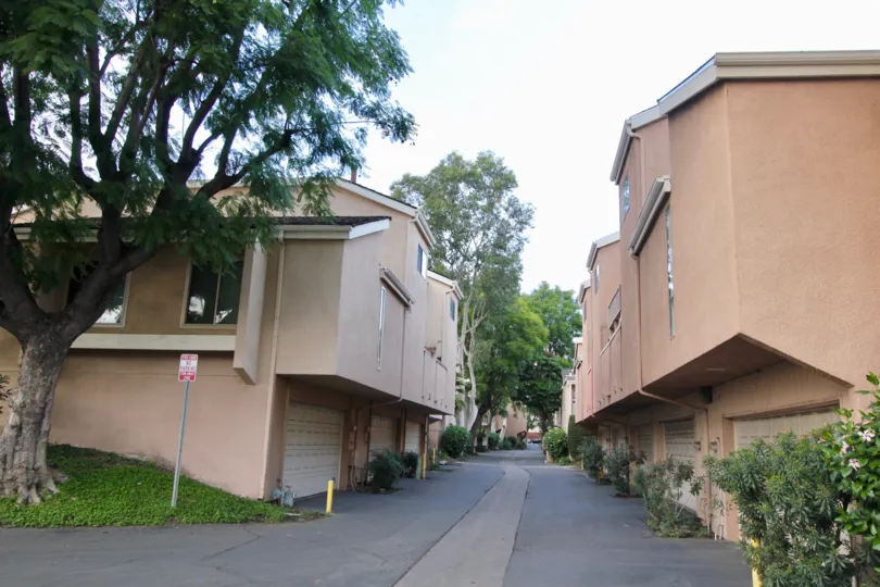 A street in Water Gardens separating apartment buildings with garages.