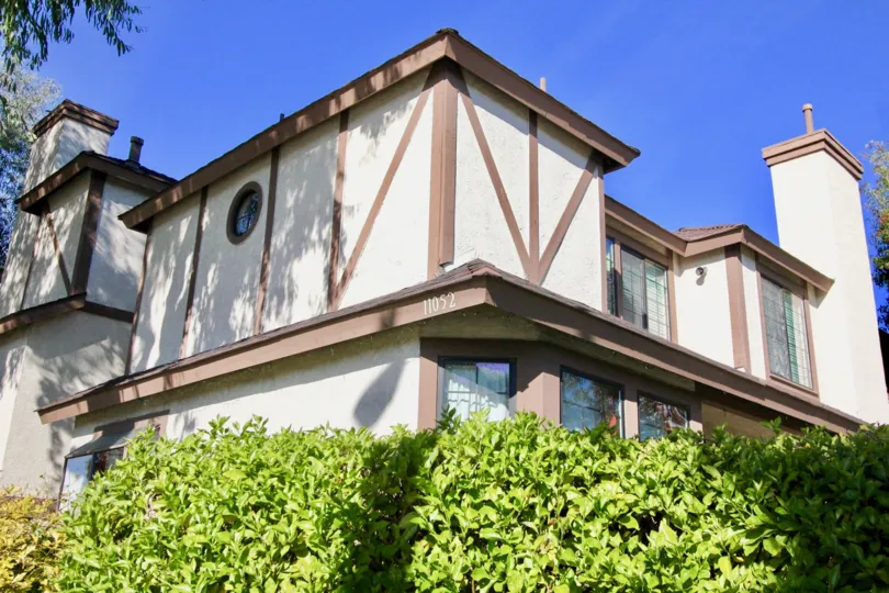 Building 11052 next to trimed shrubs in Acacia Park in Garden Grove, California