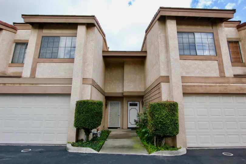 Two large condominiums with a single sidewalk leading to their entrances at Adelle Terrace in Garden Grove CA