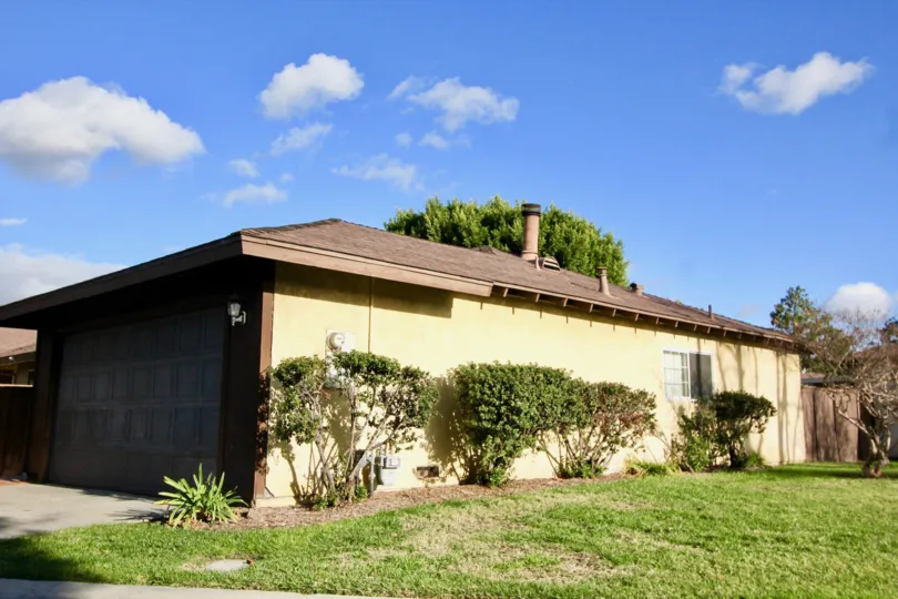 A single, retro-styled home with a wide side lawn located in the Beach Terrace area of Garden Grove, California.